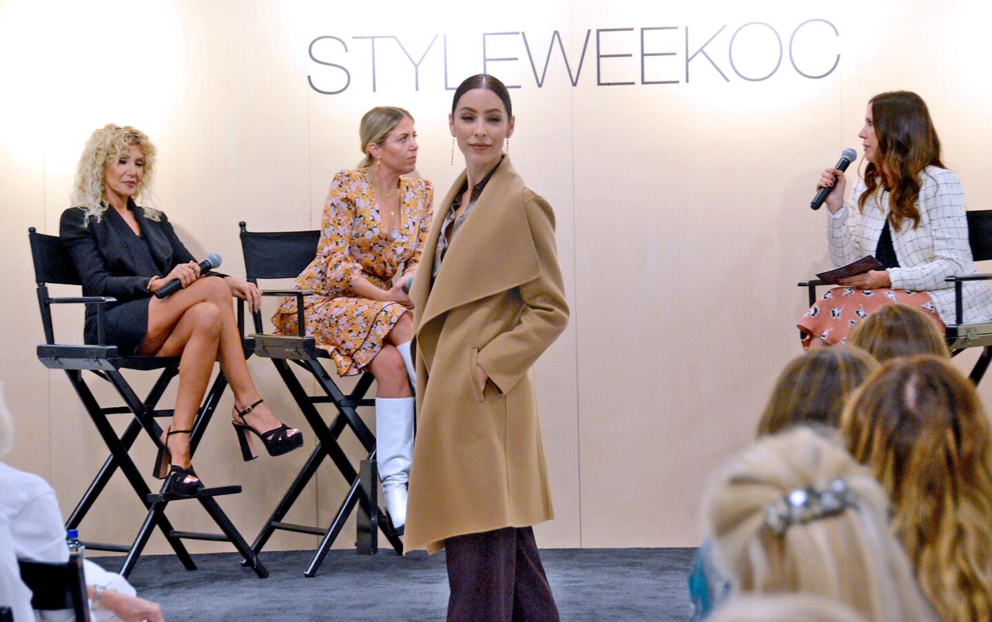 A model wears a coat by Nordstrom Signature, a blouse by Equipment and pants by Vinceduring a StyleWeekOC fashion show Thursday at Fashion Island.