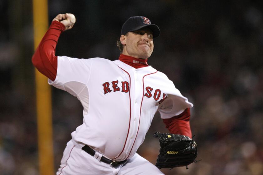 FILE - In this Oct. 25, 2007, file photo, Boston Red Sox's Curt Schilling pitches against the Colorado Rockies in Game 2 of the baseball World Series at Fenway Park in Boston. Like many baseball writers, C. Trent Rosecrans viewed the Hall of Fame vote as a labor of love. The results of the 2021 vote will be announced Tuesday, Jan. 26, 2021, and Rosecrans was not alone in finding the task particularly agonizing this time around. With Schilling's candidacy now front and center — and Barry Bonds and Roger Clemens still on the ballot as well — voters have had to consider how much a player’s off-field behavior should affect his Hall of Fame chances. (AP Photo/Kathy Willens, File)