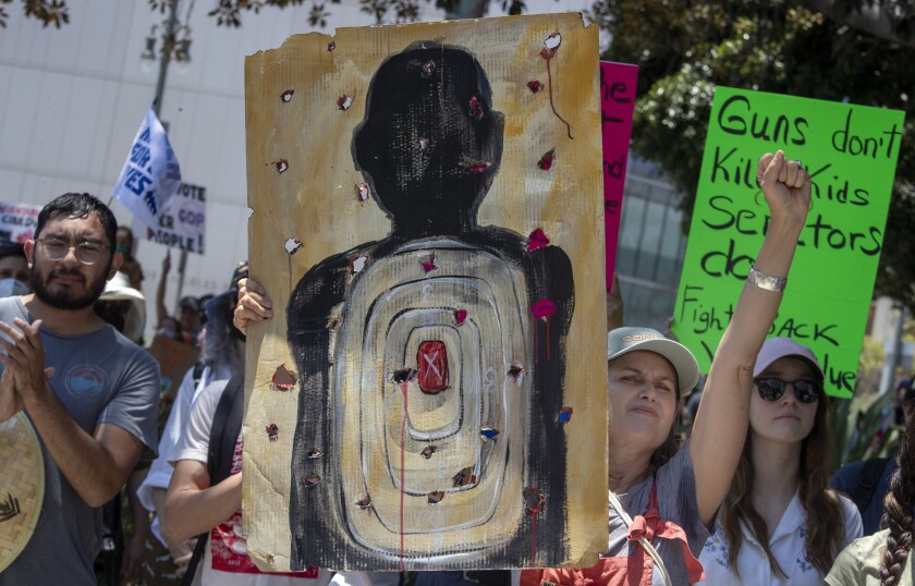 Lois Keller of Studio City thrusts her fist in the air during the March for our Lives rally downtown.