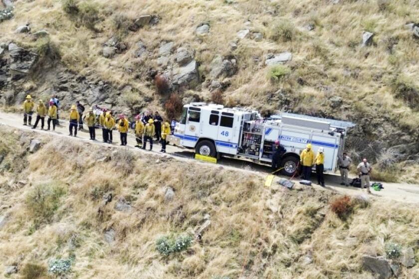 Firefighters respond to a car found on the bottom of a ravine on Comanche Point Road in Kern County on Saturday September 2, 2023.