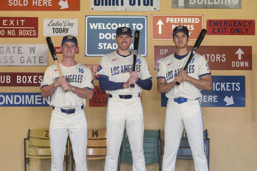 Dodgers players, from left, Will Smith, Freddie Freeman and Shohei Ohtani show off the Dodgers' new City Connect uniforms.