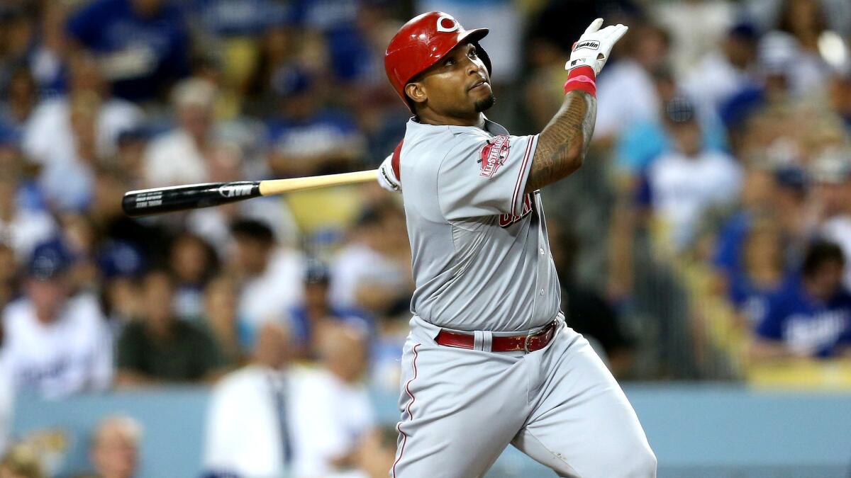 Marlon Byrd delivers a sacrifice fly for the Cincinnati Reds during a game against the Dodgers on Aug. 13.