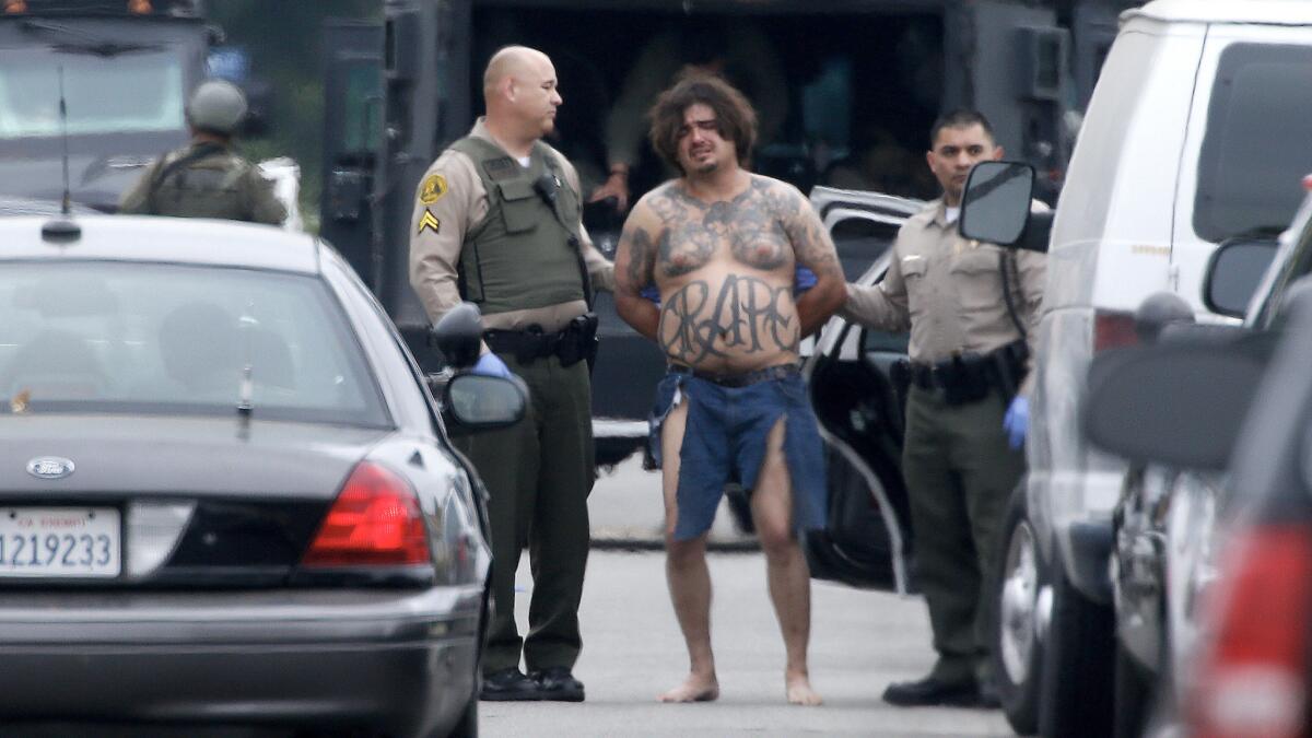 Los Angeles County sheriff's deputies take shooting suspect Juan Martinez into custody.
