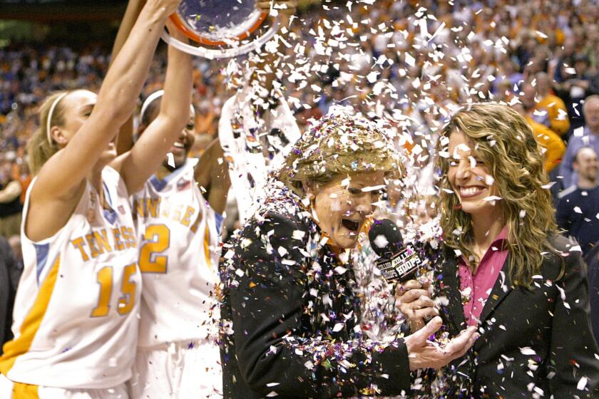 Tennessee coach Pat Summitt has confetti dumped on her by players Alicia Manning (15) and Alex Fuller (2) on Feb. 5, 2009, after the Lady Vols defeated Georgia, earning Summitt her 1,000th career coaching victory.