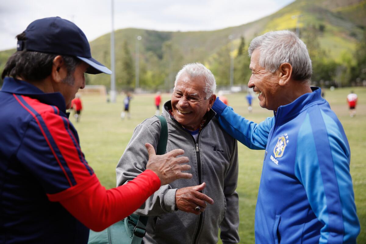 Marcos Gaitan, 90, center, says goodbye to teammates Pedro Salazar, left, and Julio Acosta after playing soccer together.