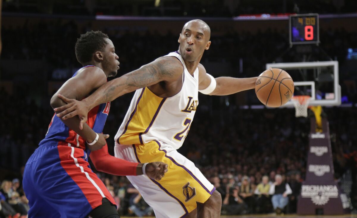Lakers guard Kobe Bryant working against Pistons forward Stanley Johnson in the first half.