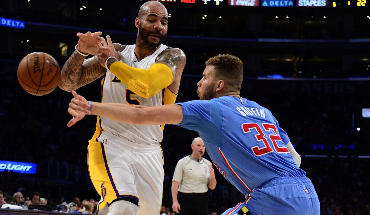 Clippers forward Blake Griffin strips the ball from Lakers forward Carlos Boozer in the first half.