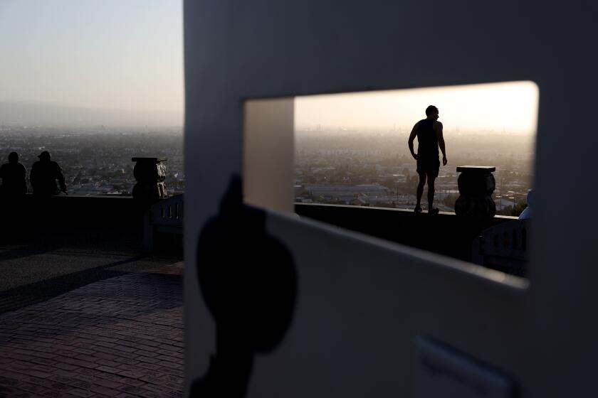 SIGNAL HILL CALIFORNIA CALIFORNIA- A man takes in the view from Hilltop Park in Signal Hill on a sunny afternoon Tuesday. (Wally Skalij/Los Angeles Times)