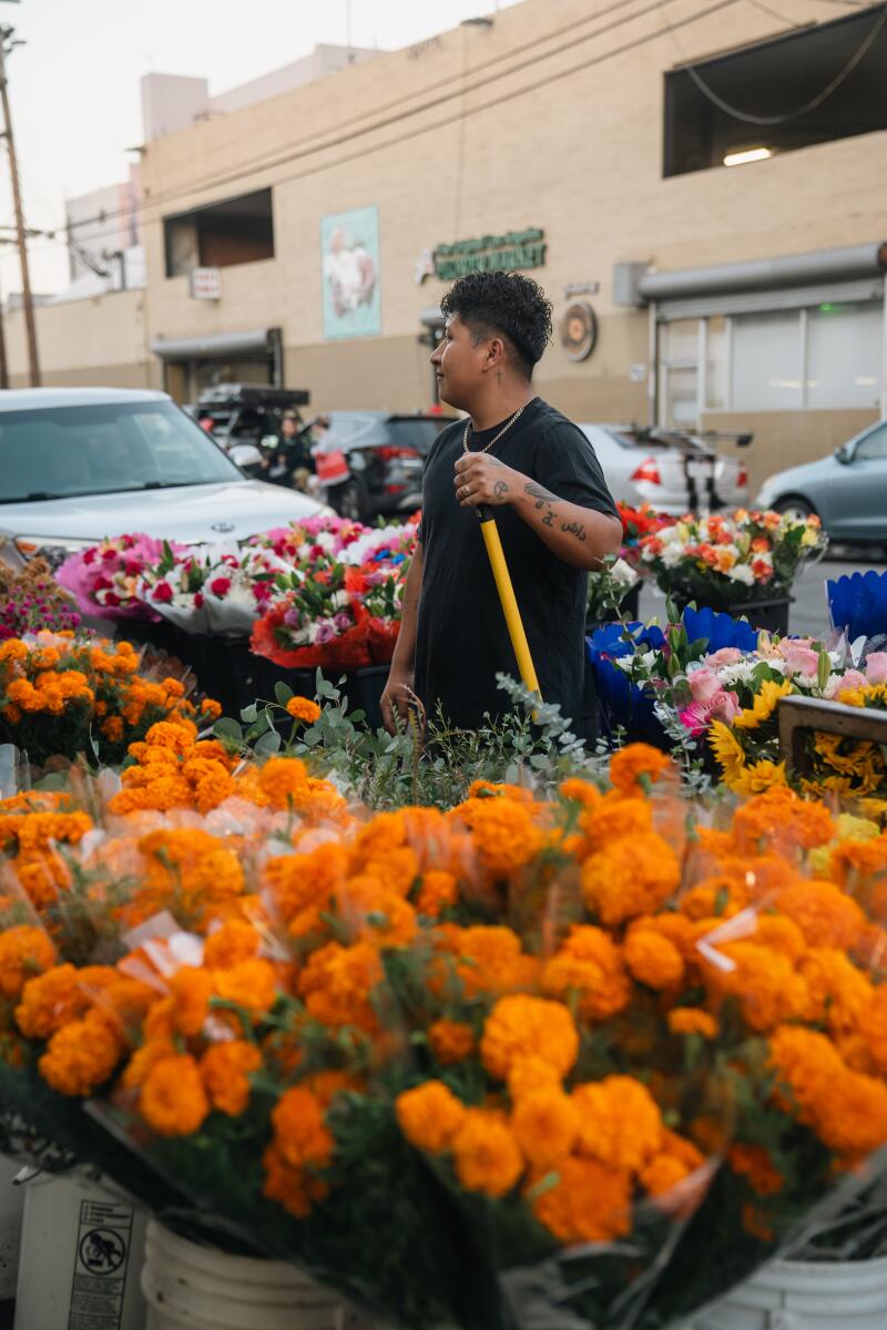 Flower market worker, Allan Barrera, taking in the street's energy and anticpaiting customers.