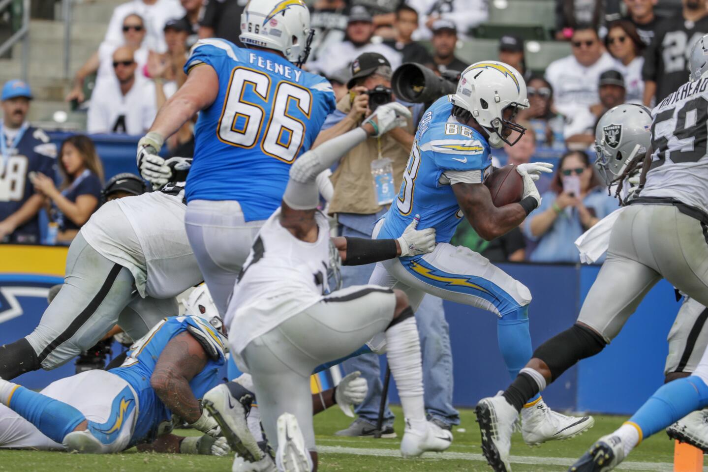Chargers tight end Virgil Green runs past Oakland Raiders defenders for a third quarter, 13-yard touchdown on a pass from Philip Rivers at StubHub Center on Sunday.
