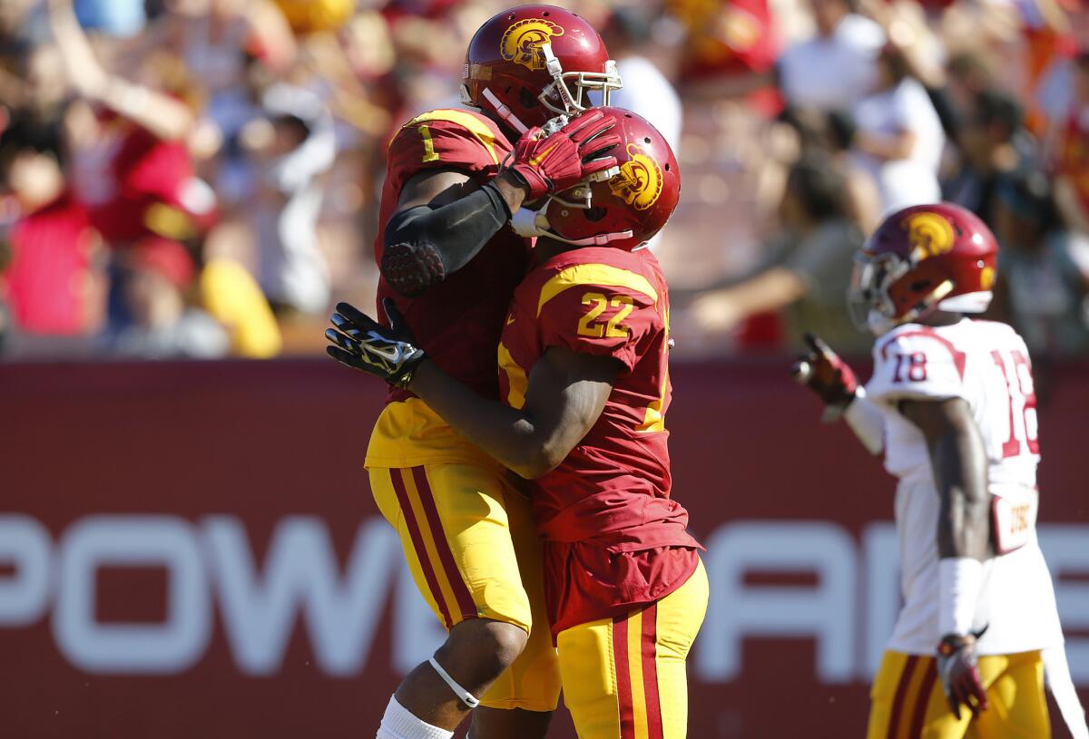 Tailback Justin Davis (22) celebrates with wide receiver Darreus Rogers (1) after scoring during the spring game on April 16. Davis ran for two touchdowns and Rogers had three receptions for 91 yards and a touchdown.