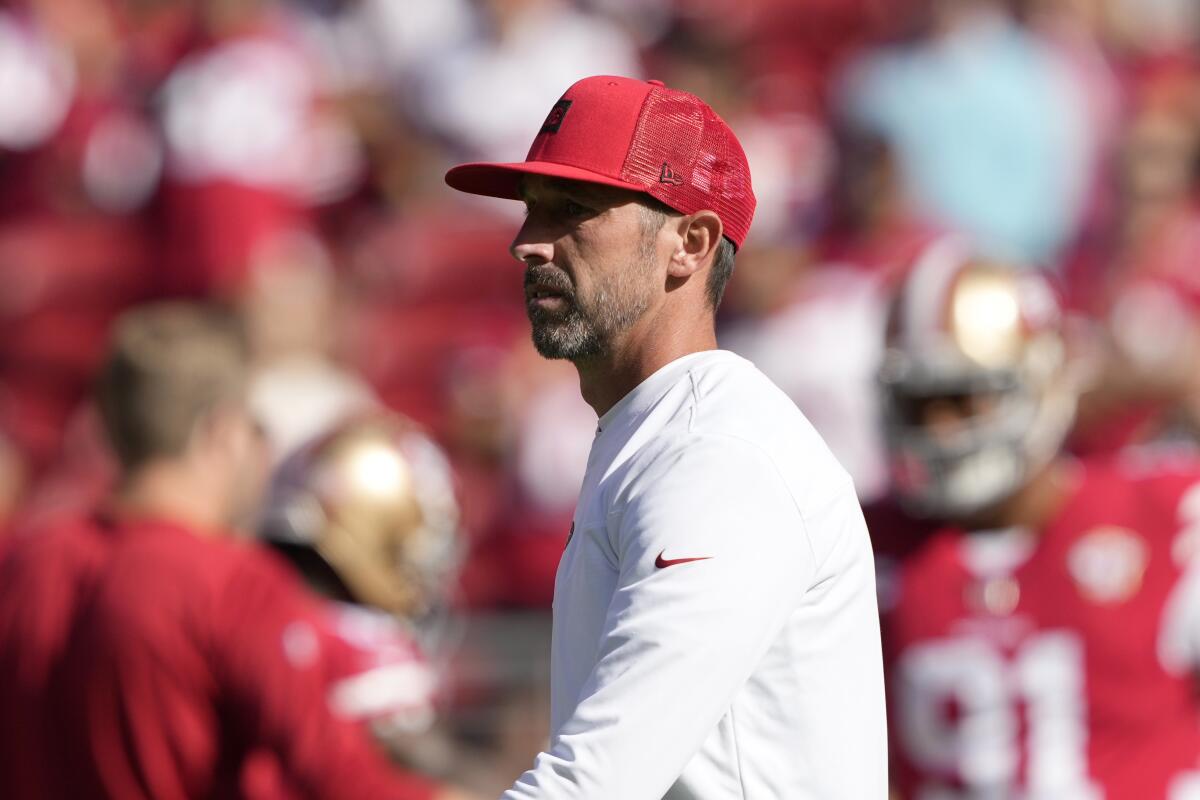 San Francisco coach Kyle Shanahan watches players warm up before their game against the Arizona Cardinals.