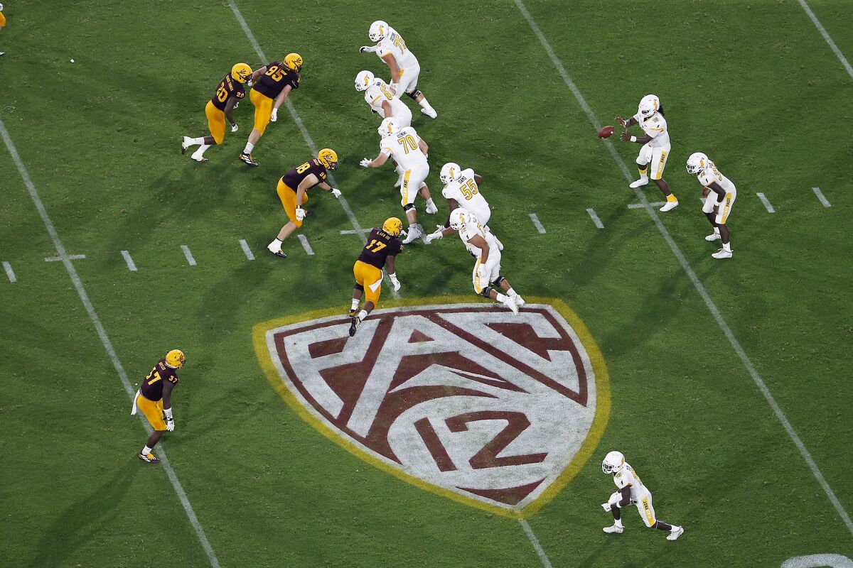 FILE - This Thursday, Aug. 29, 2019, file photo, shows the Pac-12 logo during the second half of an NCAA college football game between Arizona State and Kent State, in Tempe, Ariz. The Pac-12 has set Sept. 26 as the start of its 10-game conference-only football schedule. The Pac-12 announced three weeks ago it would eliminate nonconference games for its 12 member schools. (AP Photo/Ralph Freso, File)