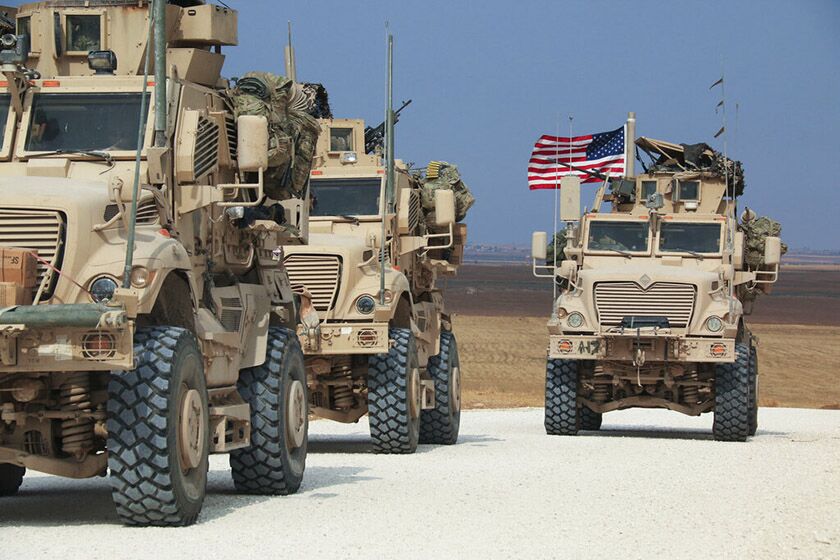 An American military convoy stops near the town of Tel Tamr, Syria, on Sunday.
