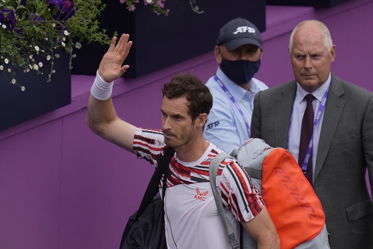 Andy Murray of Britain waves as he leaves court after he loses against Matteo Berrettini of Italy during their singles tennis match at the Queen's Club tournament in London, Thursday, June 17, 2021. (AP Photo/Kirsty Wigglesworth)
