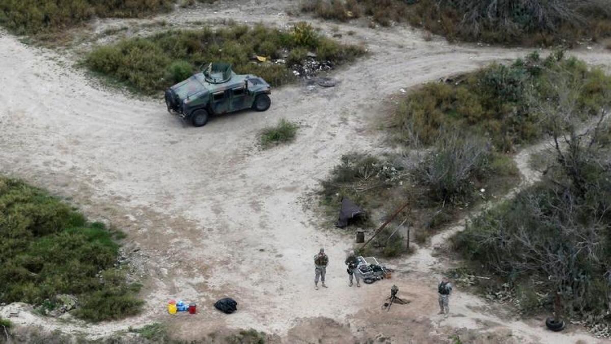 Members of the National Guard patrol along the Rio Grande at the Texas-Mexico border in Rio Grande City, Texas, in February 2015.