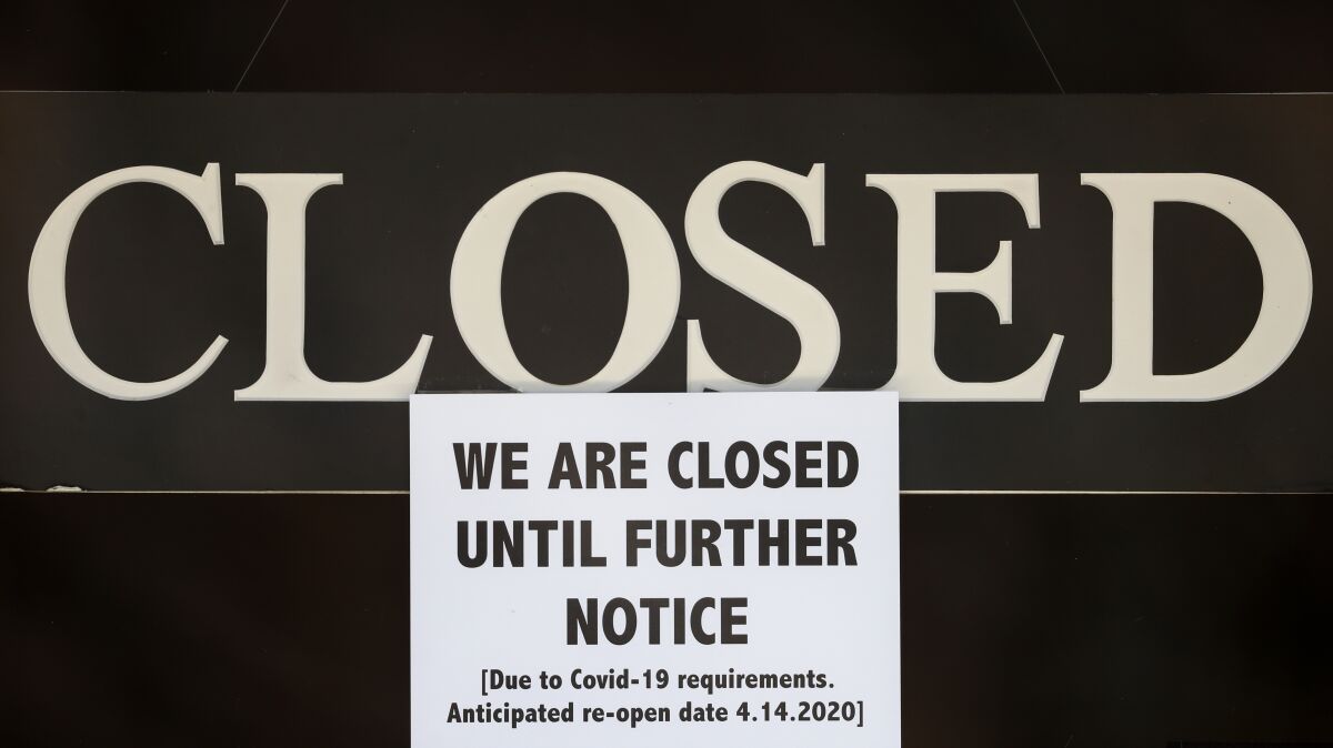 A notice of closure is posted at a business in Michigan in 2020.