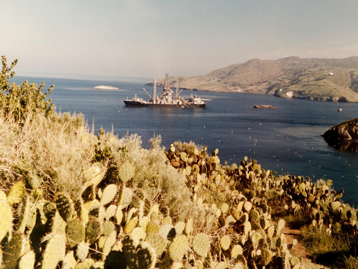 A boat floats in a bay.