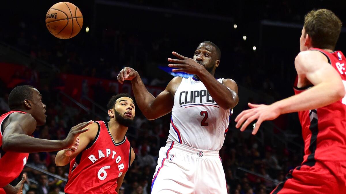 Clippers backup point guard Raymond Felton flips a pass to a teammate after driving down the lane against the Raptors in a preseason game Oct. 5.