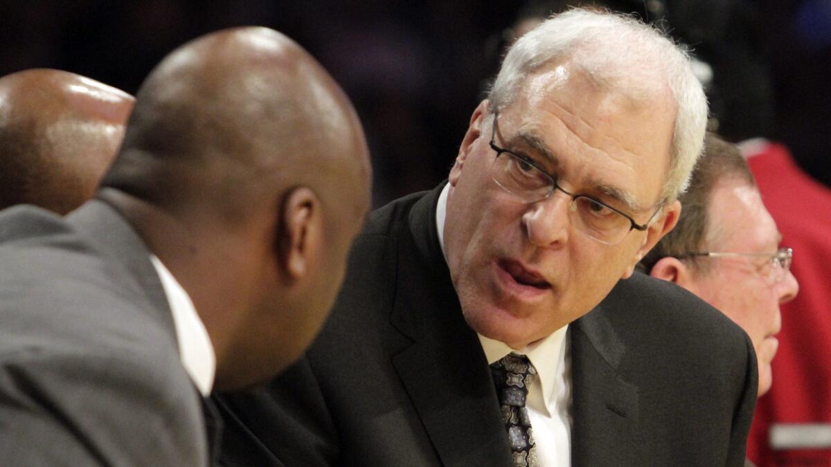 Phil Jackson responds to Chuck Person (left) in 2011 when Jackson was the head coach for the Lakers.