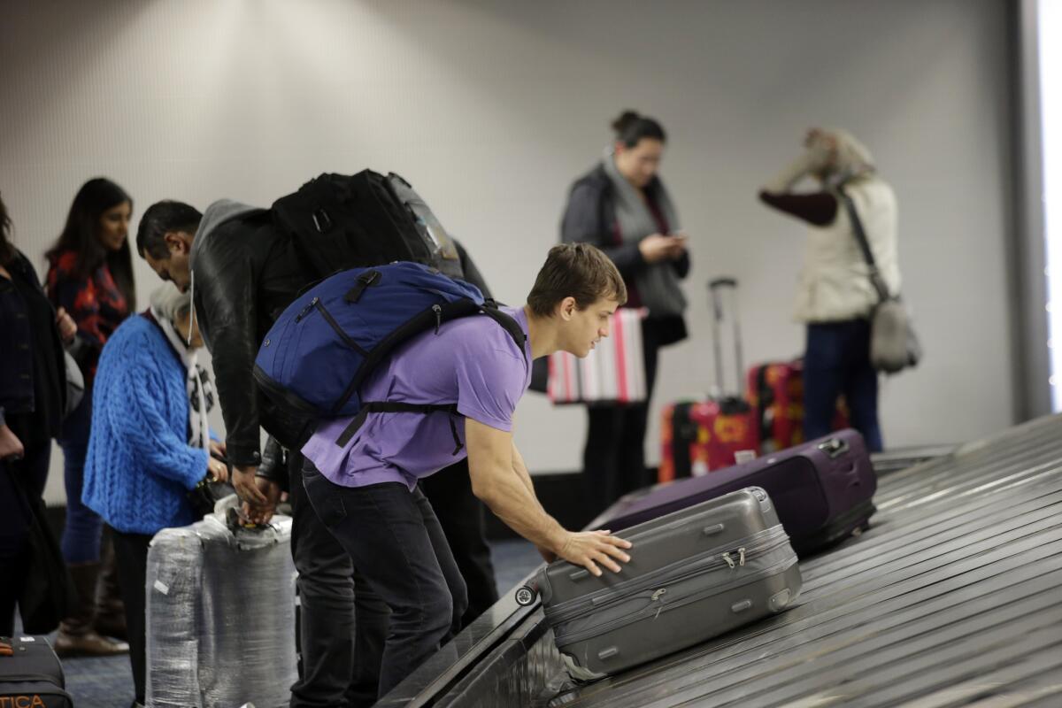 Be careful lifting and carrying luggage over the holidays. Some travelers risk injuries by not properly handling their bags.