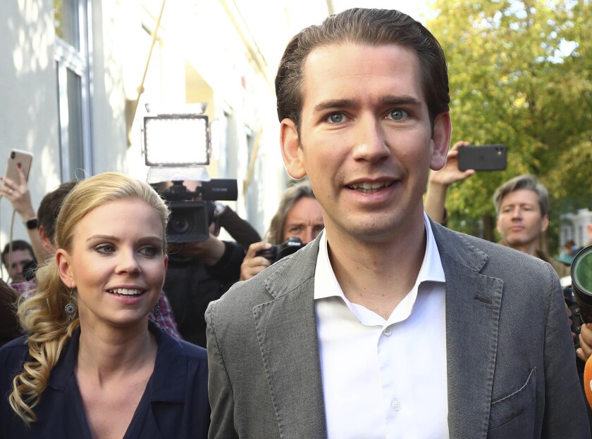 Sebastian Kurz, Austria's former chancellor and the top candidate of the Austrian People's Party, and his girlfriend, Susanne Thier, leave the polling station after casting their votes in Vienna on Sept. 29, 2019.