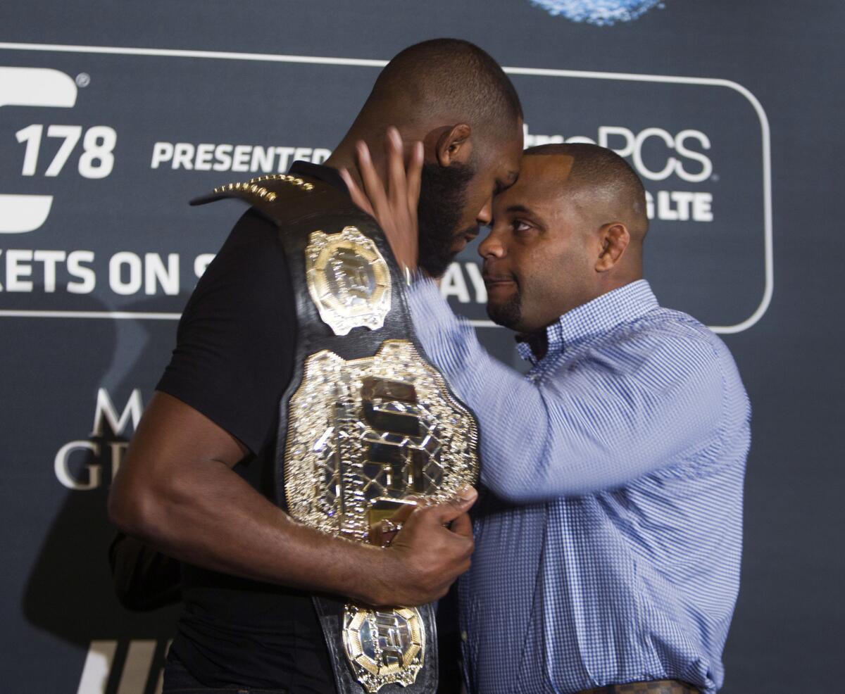 UFC light heavyweight champion Jon Jones and challenger Daniel Cormier, right, stare each other down during a news conference on Aug. 4. Jones and Cormier will meet in the ring on Saturday at the MGM Grand in Las Vegas.