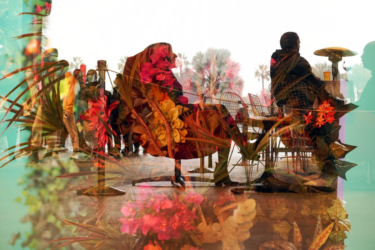 Christine Akande sips on a glass of wine and the view from Ray’s is seen in a double exposure.