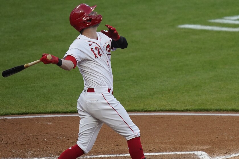 Cincinnati Reds' Tyler Naquin follows through on a home run during the third inning of the team's baseball game against the Pittsburgh Pirates at Great American Ball Park in Cincinnati, Tuesday, April 6, 2021. (AP Photo/Bryan Woolston)