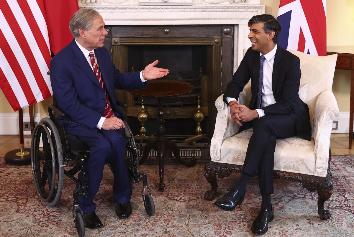 Britain's Prime Minister Rishi Sunak, right, speaks with Texas Governor Greg Abbott at Downing Street in London, Wednesday, March 13, 2024. (Peter Nicholls/Pool via AP)