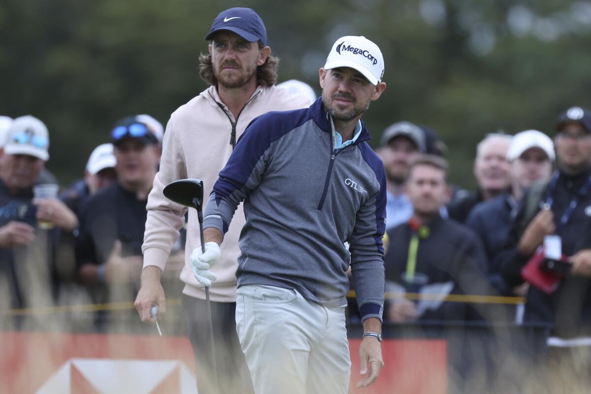 Brian Harman, right, and Tommy Fleetwood look down the  fairway on the 14th hole.