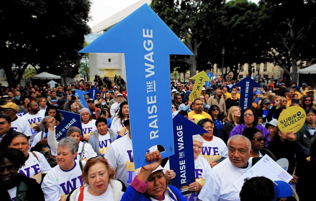 Workers, as well as business and civic leaders, rally outside L.A. City Hall in January, urging the City Council to raise the minimum wage.