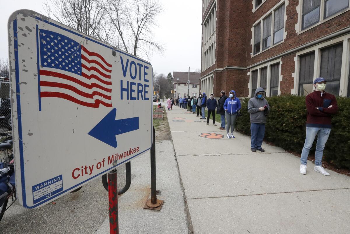 Voters line up for Wisconsin's primary election, April 7, 2020, in Milwaukee.