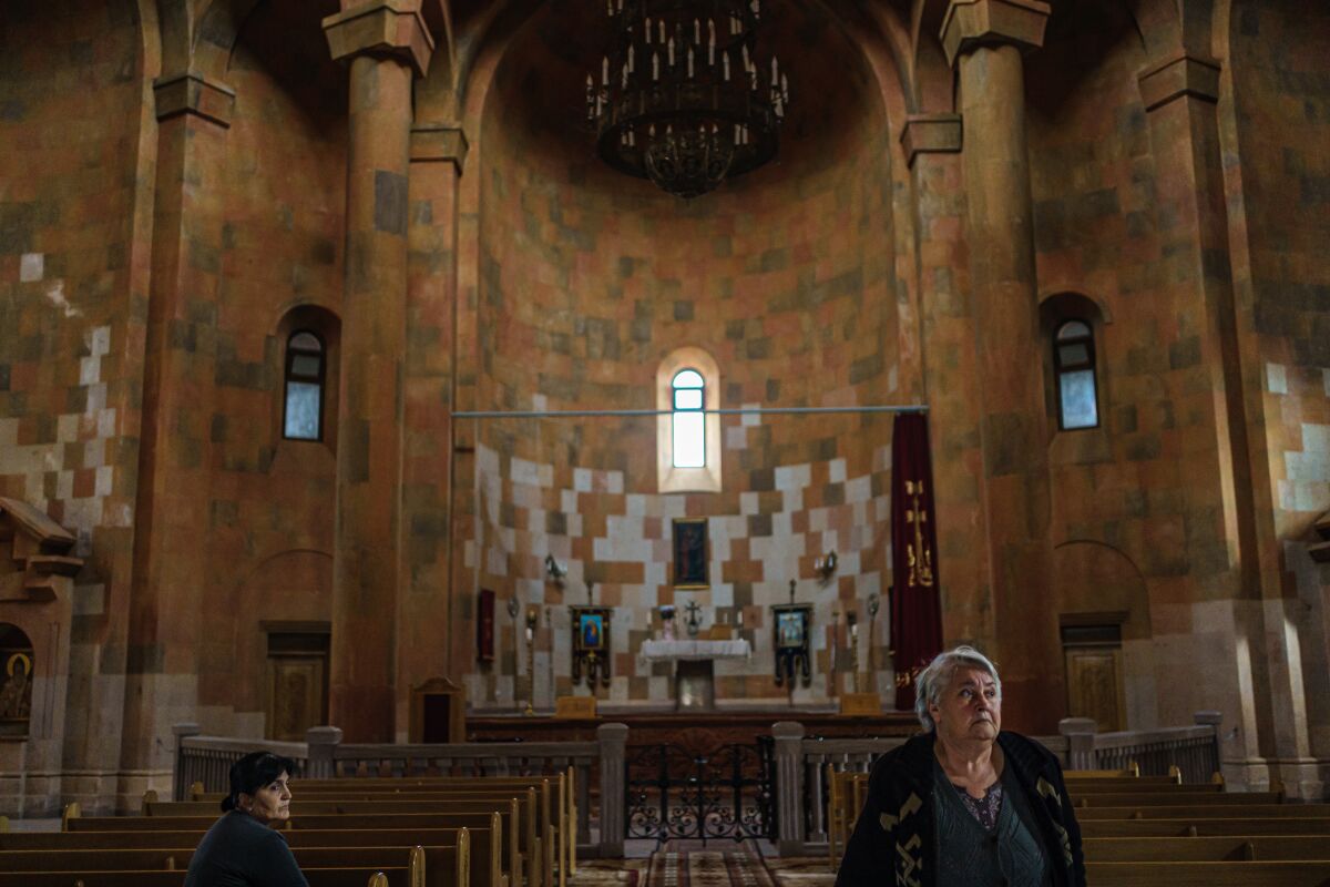 Two women visit a vintage cathedral in Stepanakert, Nagorno-Karabakh.