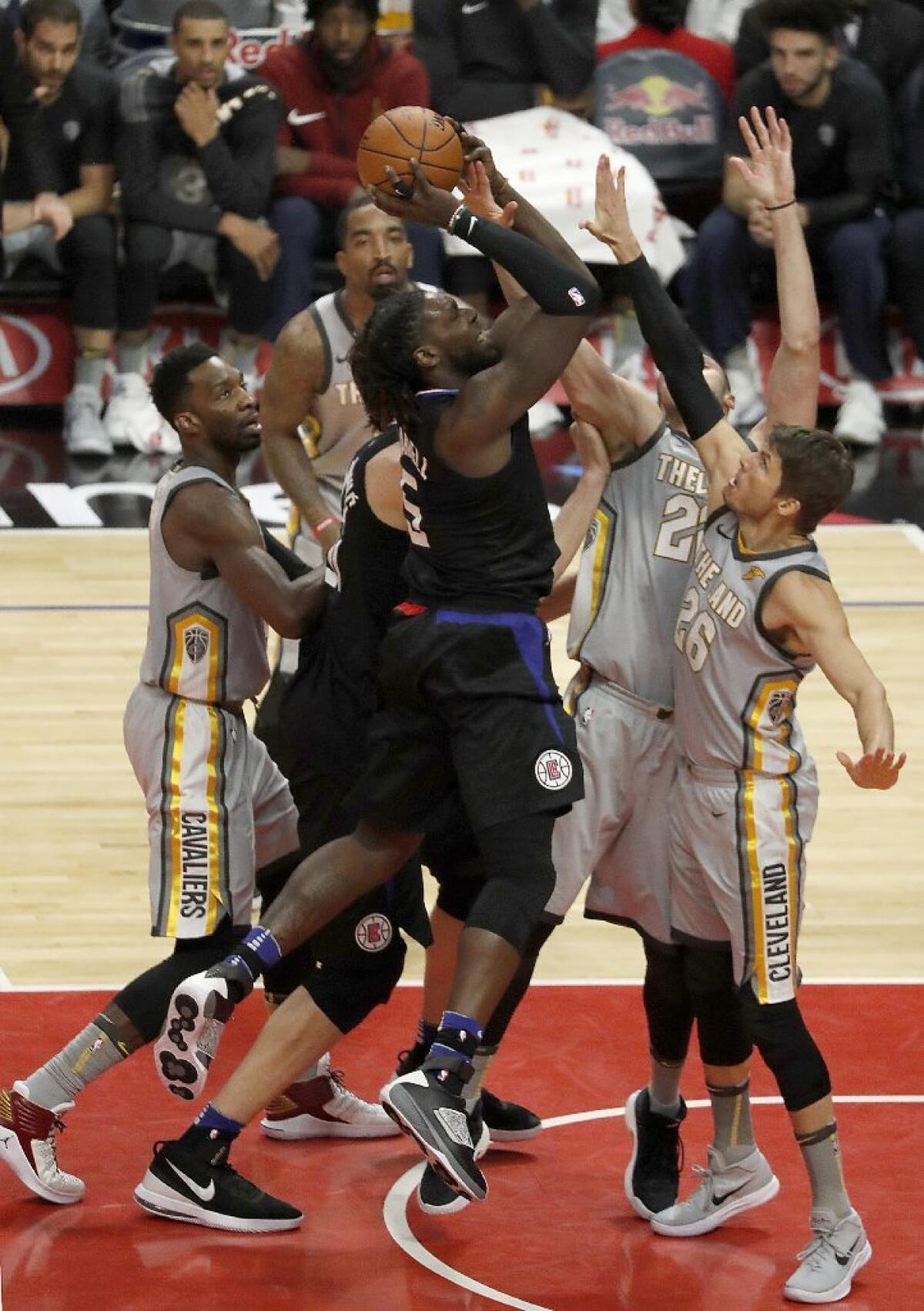 Clippers forward Montrezl Harrell puts a shot up over a bunch of Cavaliers defenders during the fourth quarter of a game Friday at Staples Center.