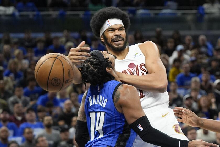 Cleveland Cavaliers center Jarrett Allen, right, is fouled by Orlando Magic guard Gary Harris (14) as he tries to pass the ball during the first half of Game 4 of an NBA basketball first-round playoff series, Saturday, April 27, 2024, in Orlando, Fla. (AP Photo/John Raoux)
