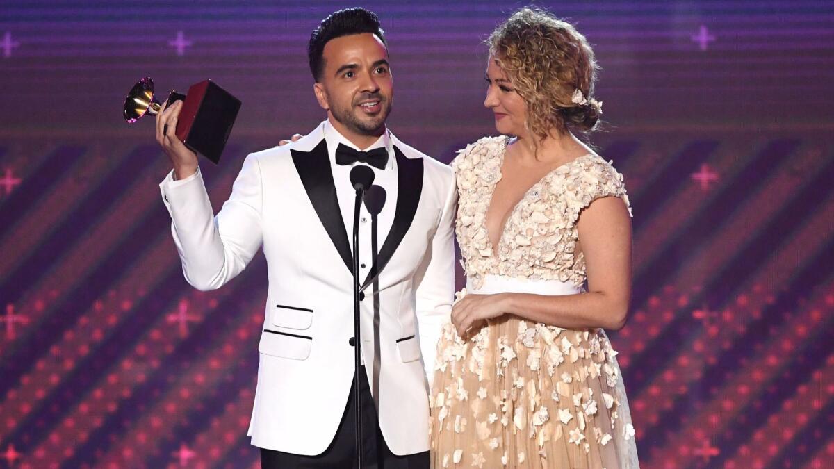 Luis Fonsi and Erika Ender accept the song of the year award for "Despacito" at the Latin Grammy Awards.