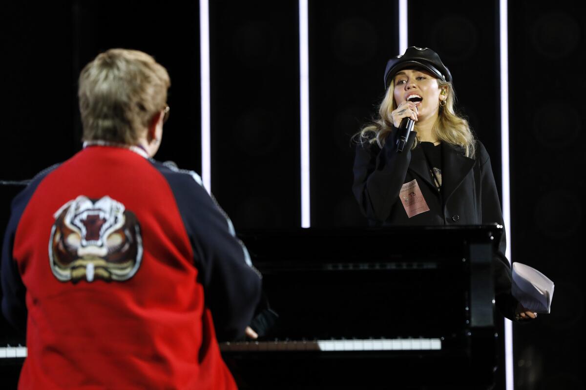 Elton John and Miley Cyrus rehearse for the 60th Grammy Awards.