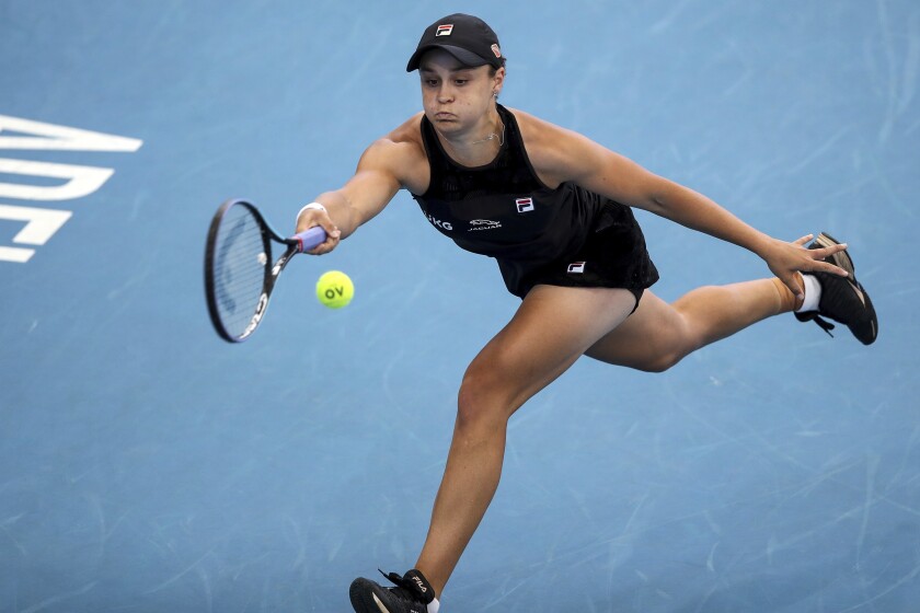 Ash Barty of Australia chases down the ball for a return to Elena Rybakina of Kazakhstan in the final of the the Adelaide International Tennis Tournament, in Adelaide, Sunday, Jan. 9, 2022. Top-ranked Barty has won her second Adelaide International title in three years with a 6-3, 6-2 win over Elena Rybakina on Sunday. (Matt Turner/AAP Image via AP)