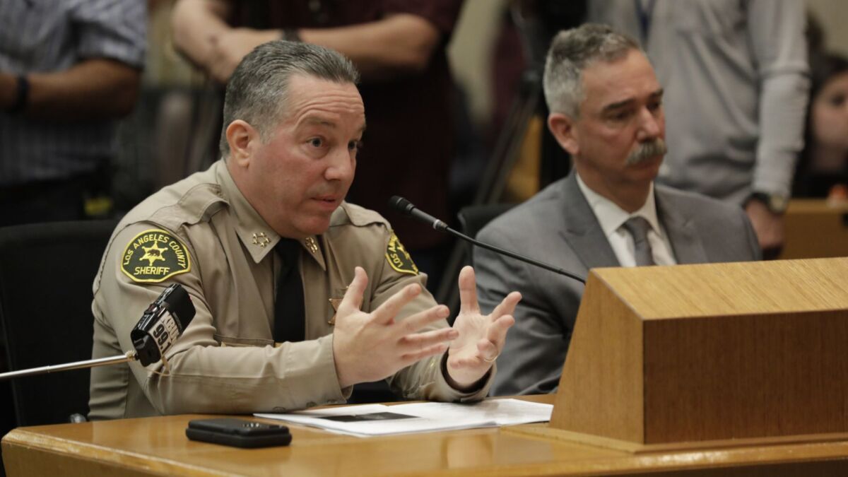 Sheriff Alex Villanueva speaks in front of the L.A. County Board of Supervisors.