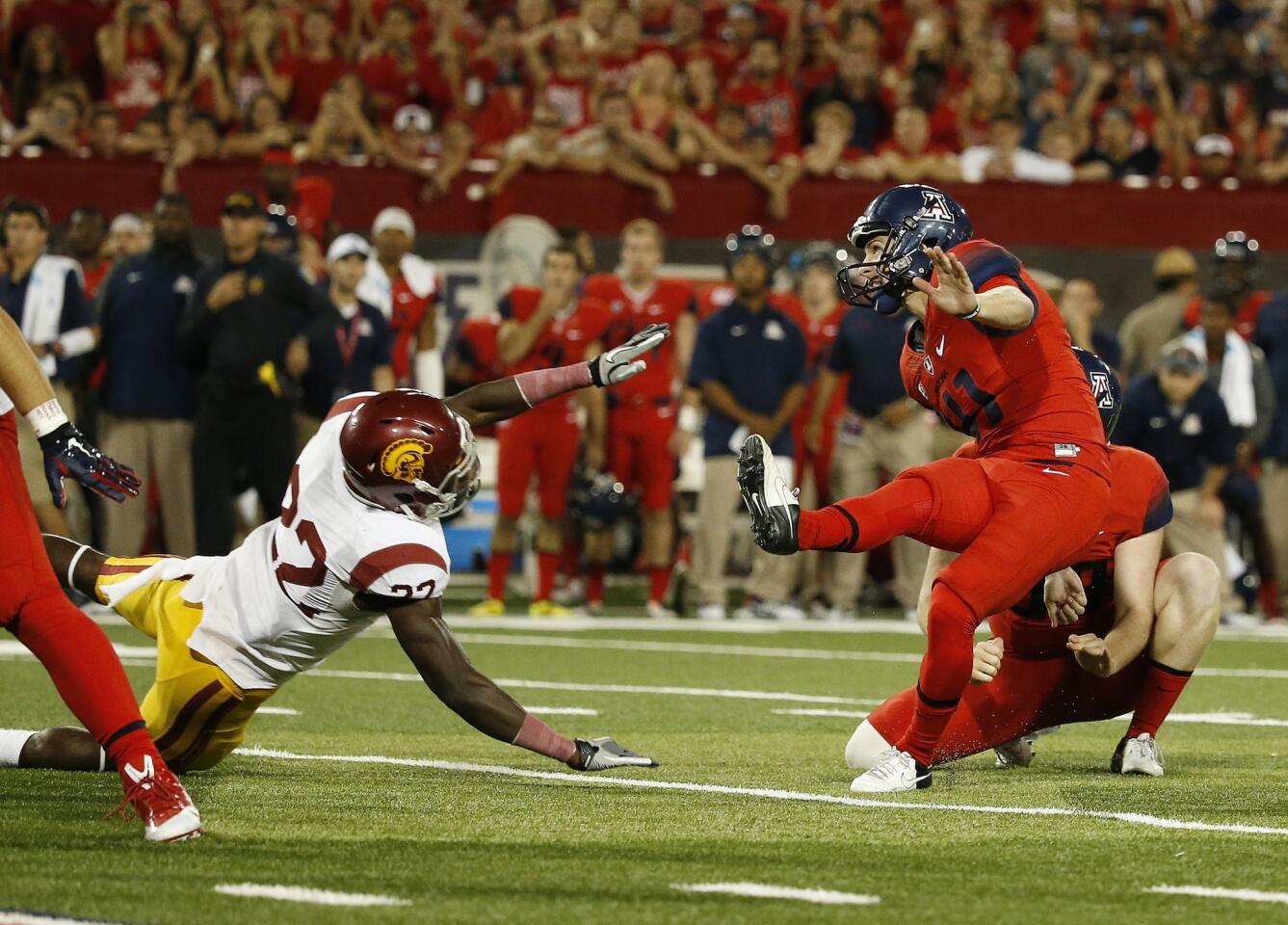 Arizona kicker Casey Skowron misses a 36-yard field-goal attempt in front of USC safety Leon McQuay in the closing seconds of the Trojans' 28-26 victory Saturday.