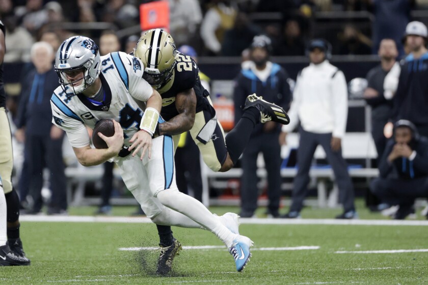 New Orleans Saints defensive back Chauncey Gardner-Johnson (22) sacks Carolina Panthers quarterback Sam Darnold (14) in the second half of an NFL football game in New Orleans, Sunday, Jan. 2, 2022. The Saints won 18-10. (AP Photo/Derick Hingle)