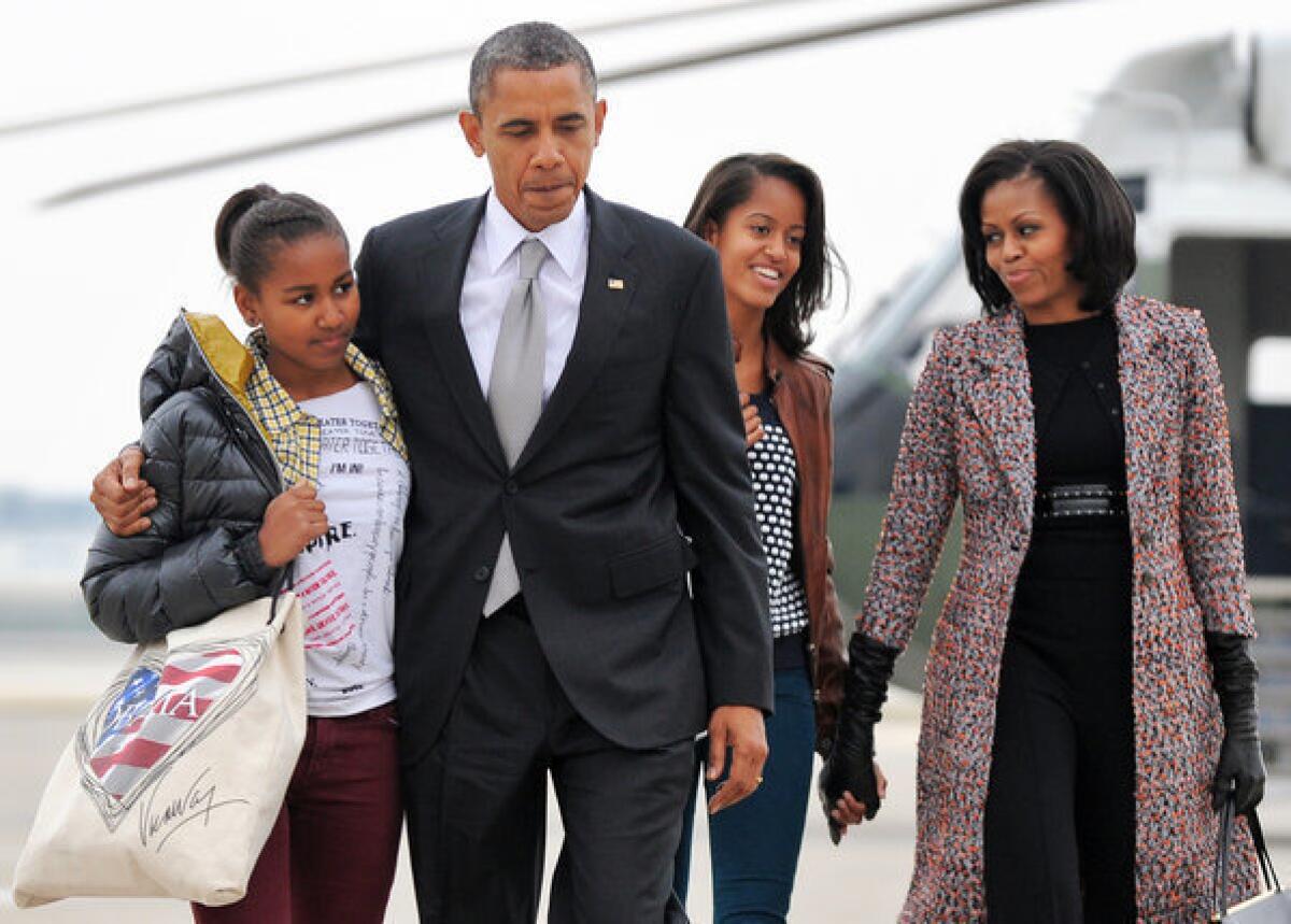 President Obama and First Lady Michelle Obama, with their daughters, Malia and Sasha, prepare to leave Chicago for Washington on Wednesday, the day after the president was reelected.