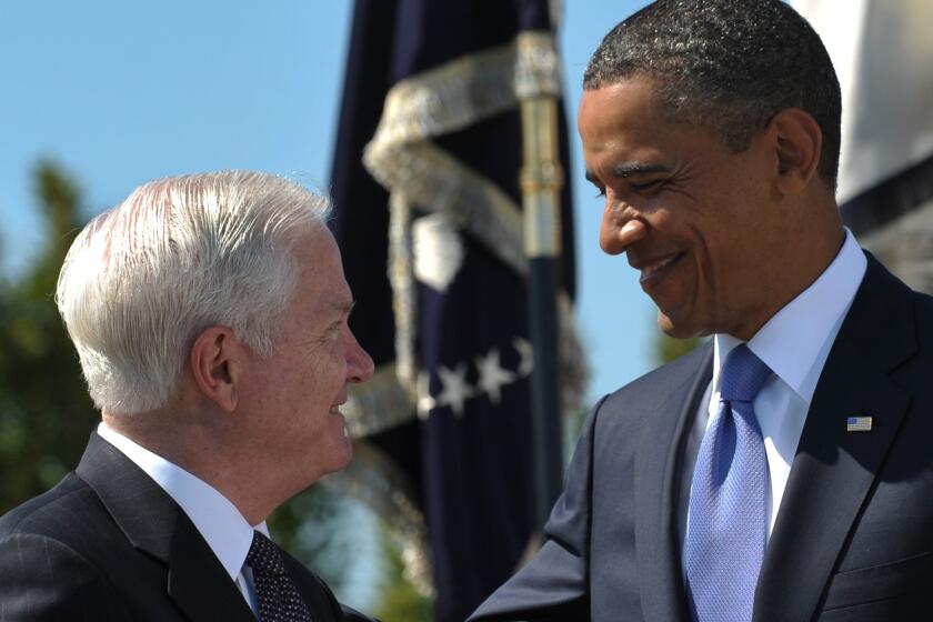 President Obama smiles at outgoing U.S. Defense Secretary Robert Gates after presenting him the Medal of Freedom during the Armed Forces Farewell Tribute in honor of Gates at the Pentagon in Washington, D.C., in 2011.