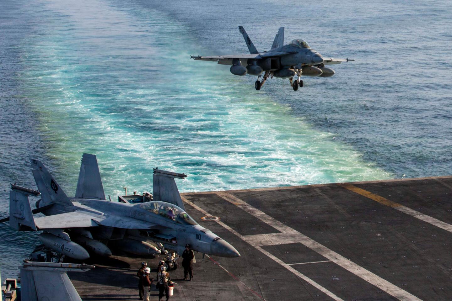 This image provided by U.S. Central Command shows a F/A-18E Super Hornet preparing to make an arrested landing on the USS Abraham Lincoln (CVN 72) after a mission in support of Operation Epic Fury, on Saturday, Feb. 28, 2026. (U.S. Navy via AP)