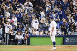 Los Angeles, CA - October 11: Fans cheer on Los Angeles Dodgers starting pitcher Julio Urias after Urias strikes out San Diego Padres' Trent Grisham during the third inning of game one of the NLDS at Dodger Stadium on Tuesday, Oct. 11, 2022 in Los Angeles, CA.(Gina Ferazzi / Los Angeles Times)