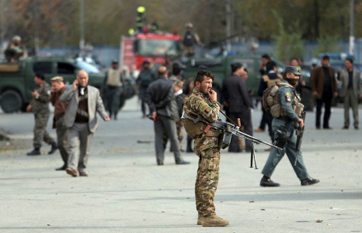 Afghan security forces in Kabul inspect the site of a deadly blast near a demonstration on Nov. 12, 2018, against Taliban attacks in Ghazni province.