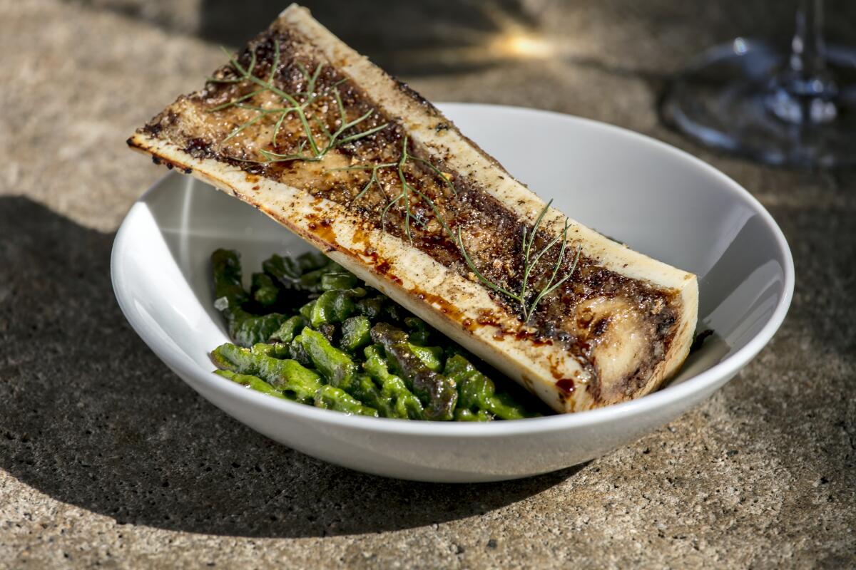 Roasted marrow bone with spinach gnocchetti, crispy breadcrumbs and aged balsamic