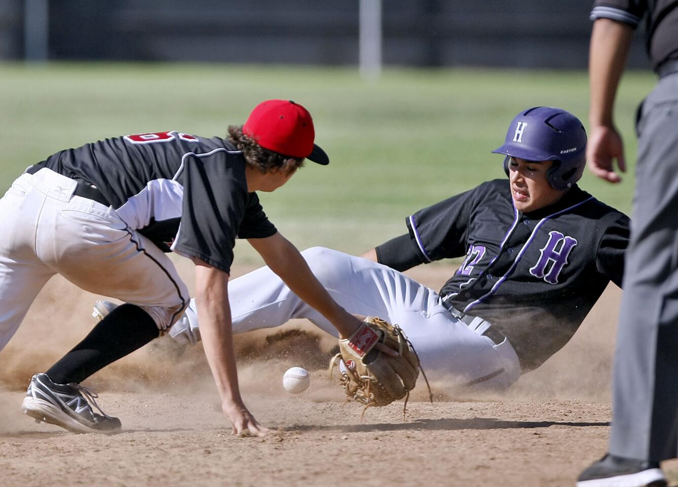 Glendale High's #16 Ethan Howard can't come up with the ball in time as crosstown rival Hoover High's #32 Orlando Marin slides in safely at second base with a 2-run RBI double during game at home in Glendale on Friday, April 19, 2013.