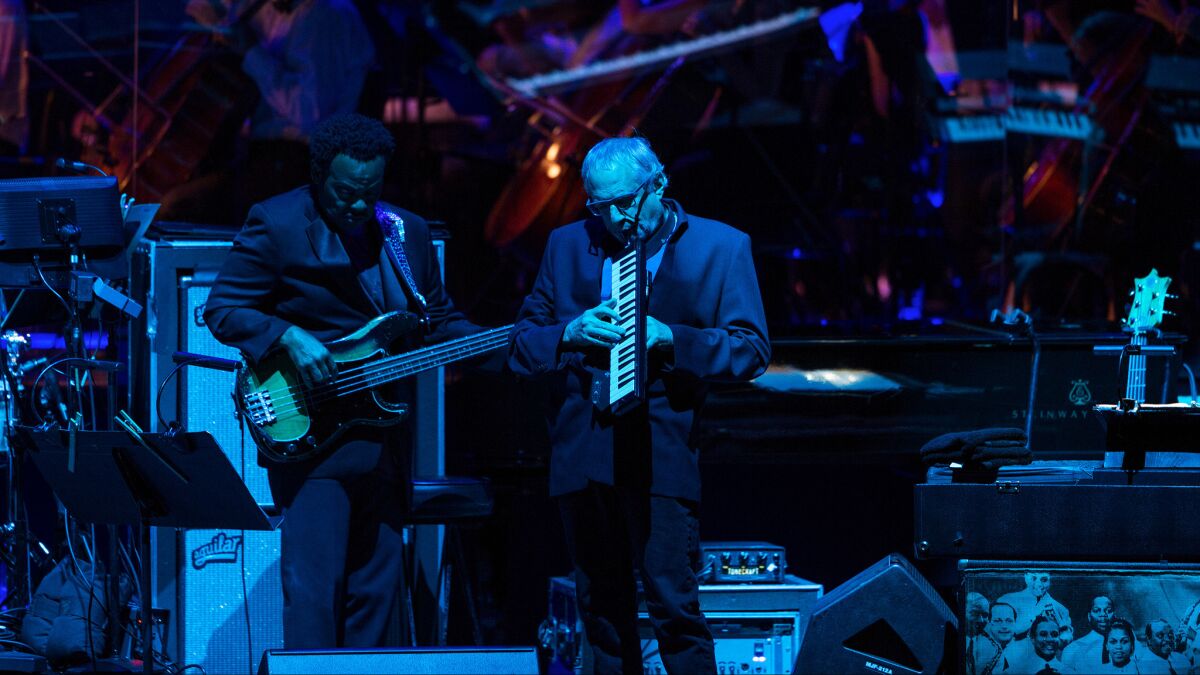 Donald Fagen (center) co-founded Steely Dan in 1972 and is forging ahead without guitarist and band co-founder Walter Becker (not pictured), who died in 2017. Fagen is shown above with bassist Freddie Washington at a Hollywood Bowl concert by Steely Dan.